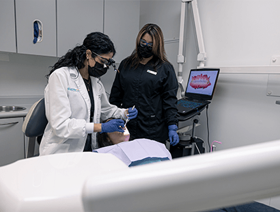 Woman putting in a clear aligner tray 