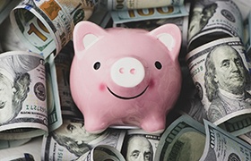 Piggy bank for cost of cosmetic dentistry in New Bedford
