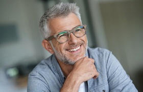 older man with glasses smiling