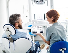 patient and dentist discussing cost of dental implants in New Bedford