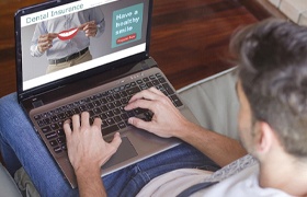 Man searching dental insurance in New Bedford