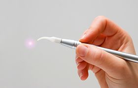 Hand holding a soft tissue laser