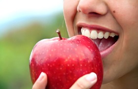 close up person eating apple