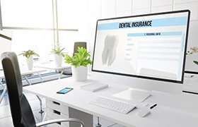 Dental insurance form displayed on large computer monitor