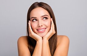 Woman touching her face and smiling