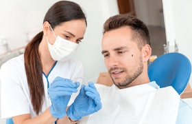 Man at dentist getting Invisalign in New Bedford