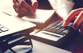 Woman calculating cost of Invisalign in New Bedford