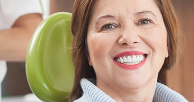 Older woman in dental chair smiling