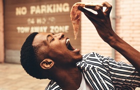 person eating a slice of pizza
