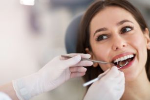 Smiling woman getting a dental exam