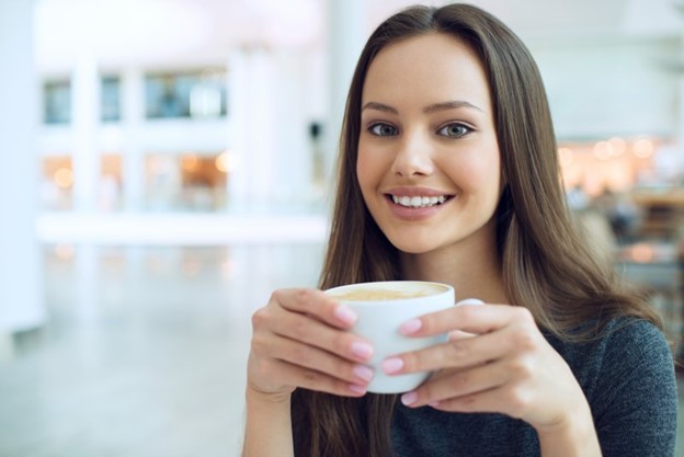 Woman drinking a cup of coffee.