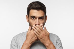 man covering mouth