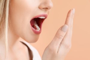 a woman checking if her breath is fresh