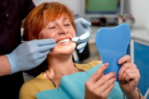 Woman smiles in dentists chair