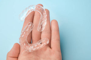 Clear aligners in opened hand