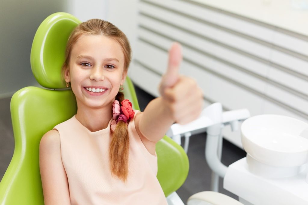 child at the dentist for a tooth extraction