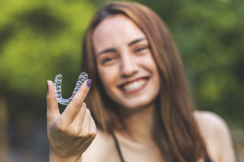 person holding Invisalign