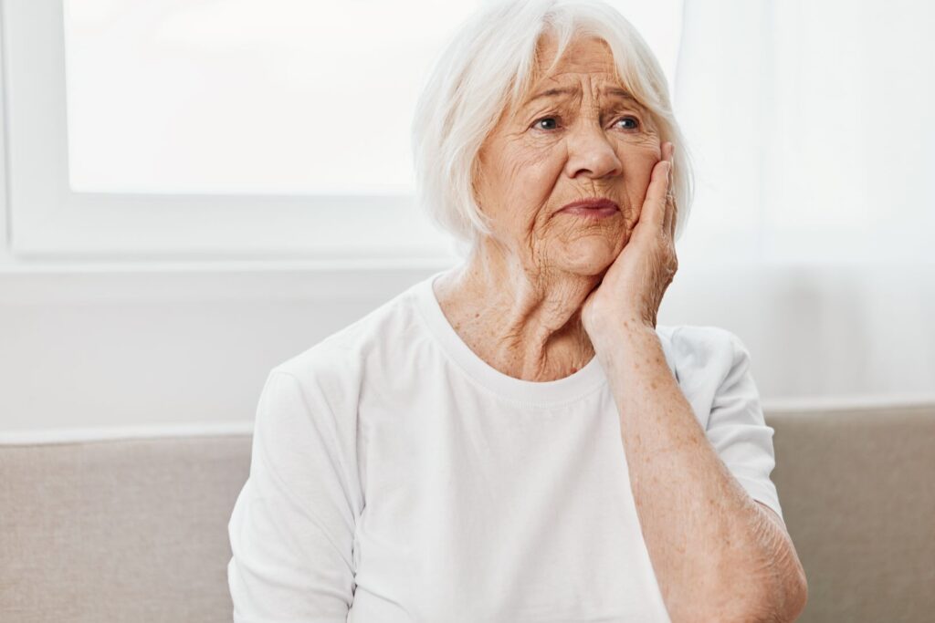 A woman holding her jaw