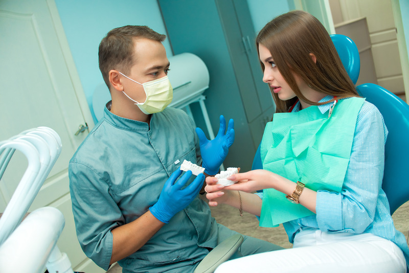 Patient talking to dentist about their dental implant