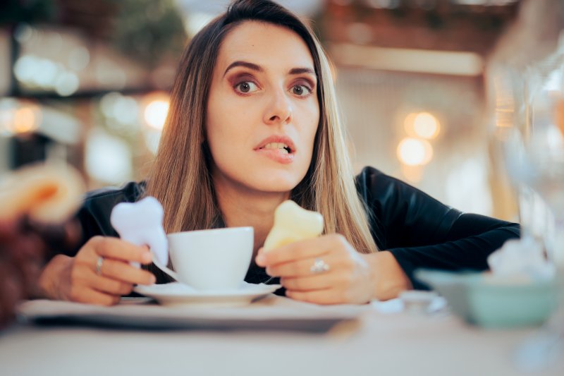 woman with stained and white teeth and a coffee cup